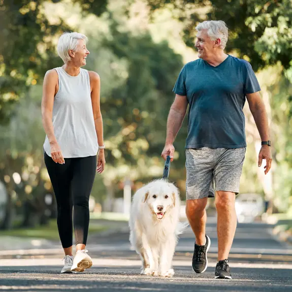 Two People Walking Dog