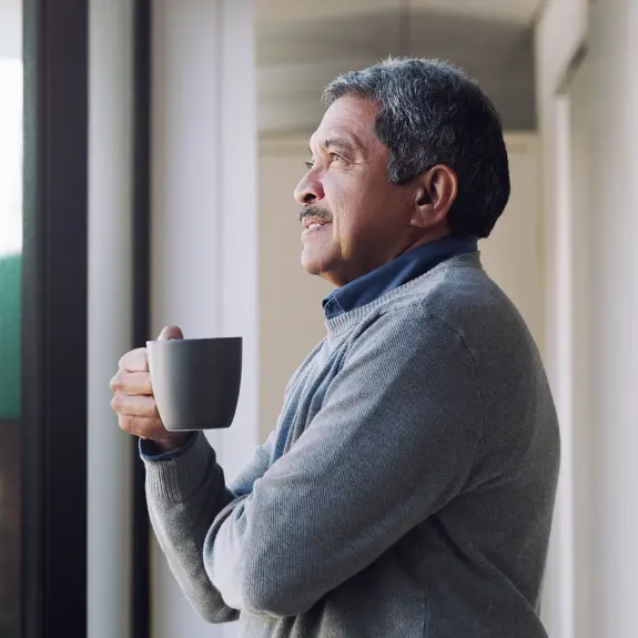 Man Stood Looking Out Through Window